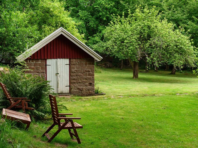 Garden storage shed next to a lawn