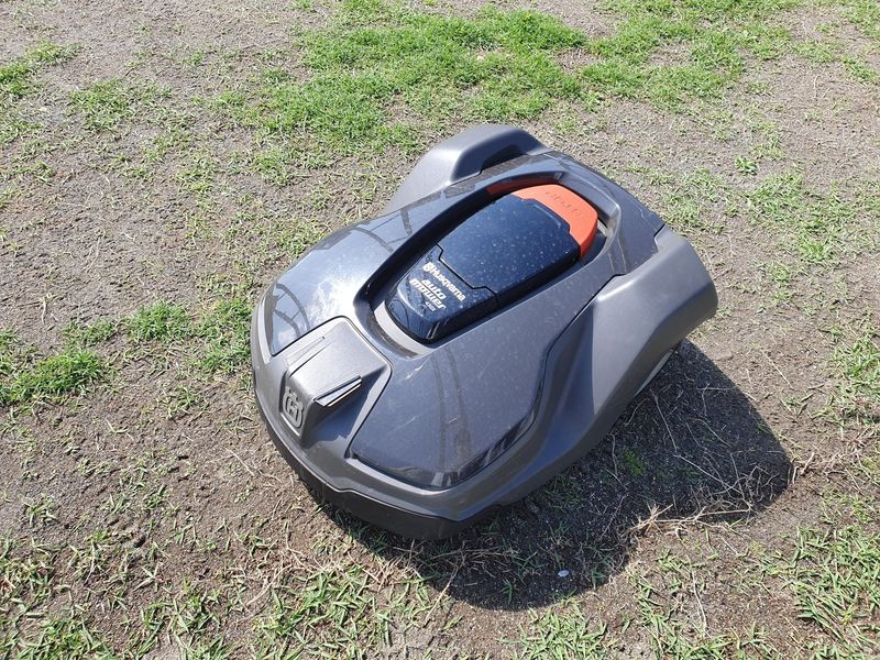 Husqvarna Automower 430X on a worn lawn at the end of the season